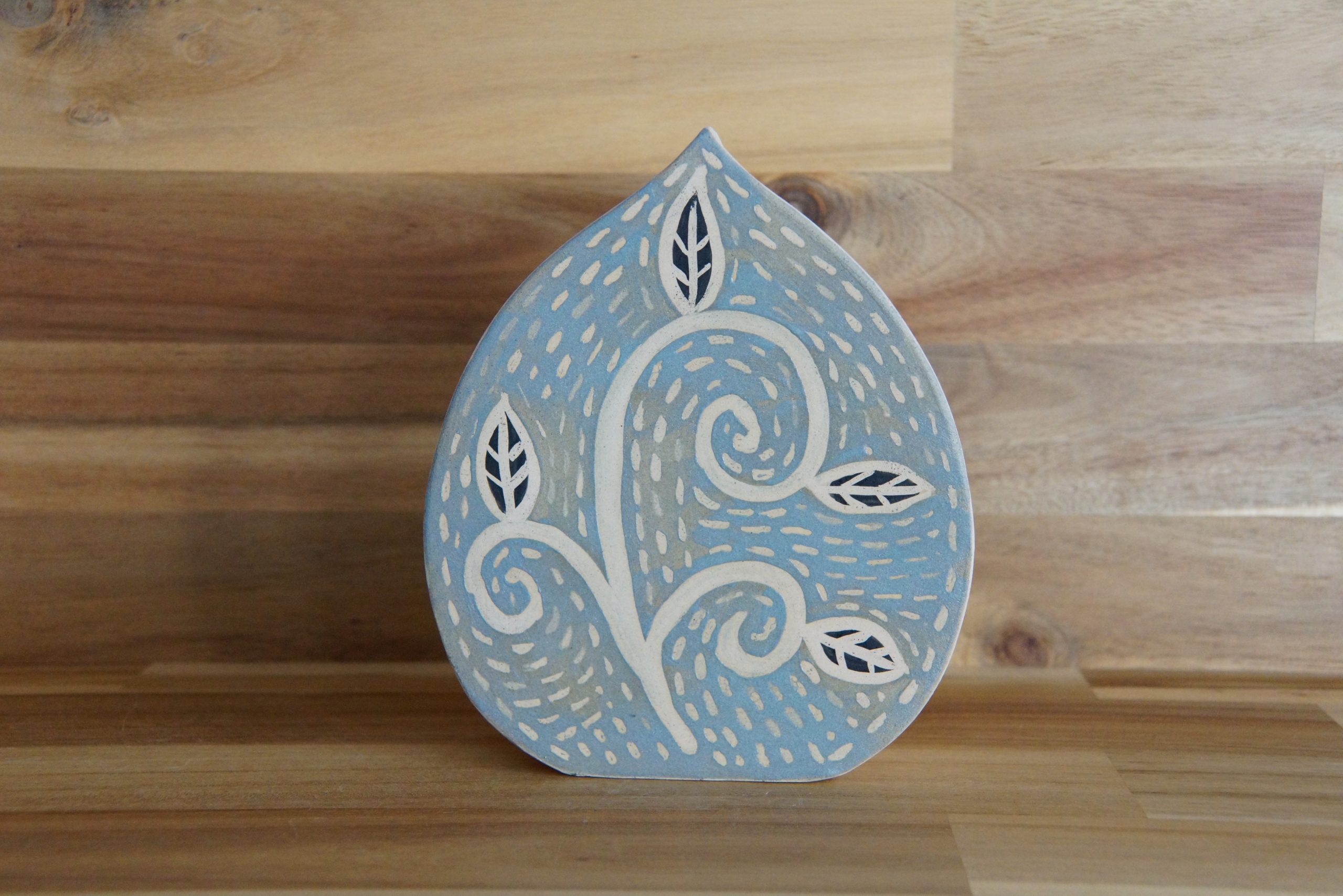 A blue glazed ceramic pottery vase with patterned finish